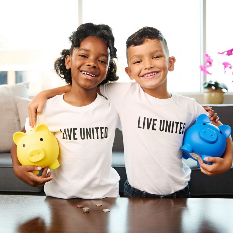 two boys playing with a robot
