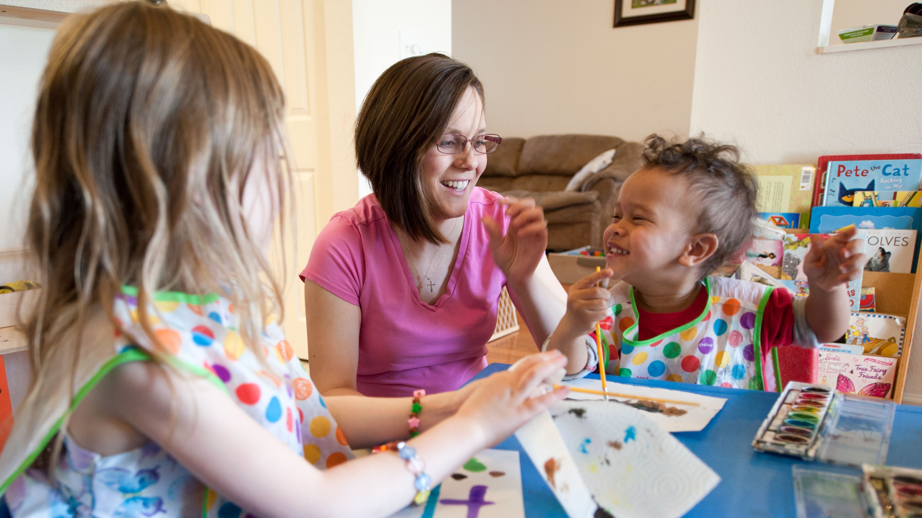 woman with children painting