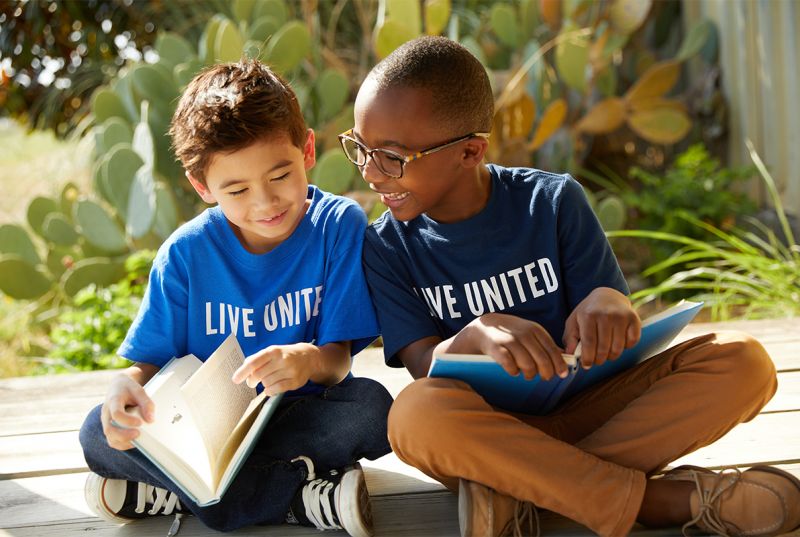 two boys reading books