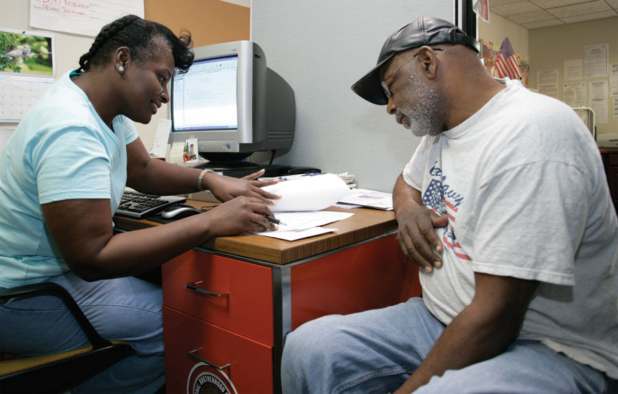 a woman reviews forms with a man