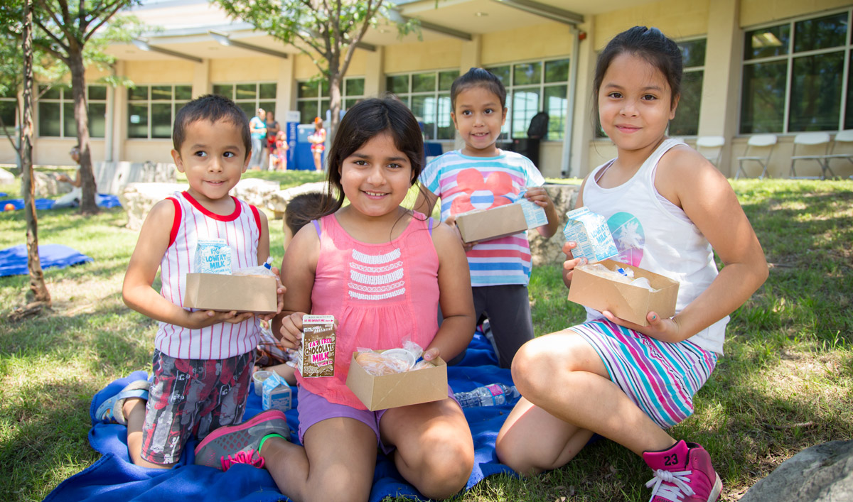 group of kids having a picnic with their lunches