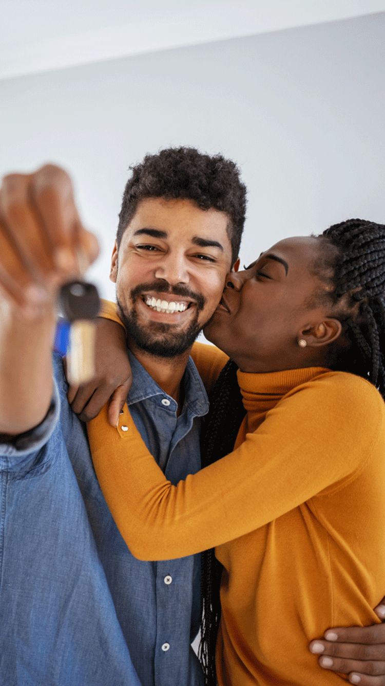 young couple with keys in their hand