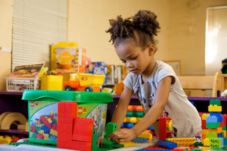 little girl plays with blocks