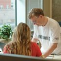 gentleman helps gorgeous haired woman with taxes