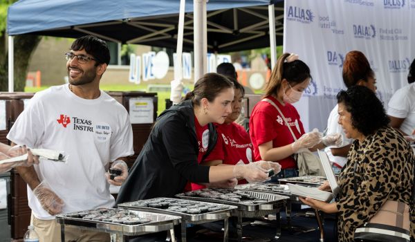 father showing sons how to build, United Way Stock the School